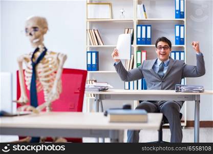 The businessman working with skeleton in office. Businessman working with skeleton in office