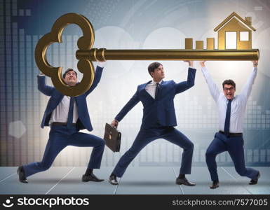 The businessmen holding giant key in real estate concept. Businessmen holding giant key in real estate concept