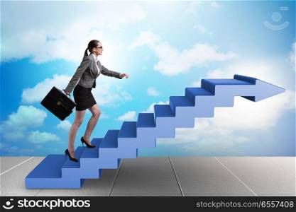 The businesswoman climbing career ladder in business concept. Businesswoman climbing career ladder in business concept. The businesswoman climbing career ladder in business concept