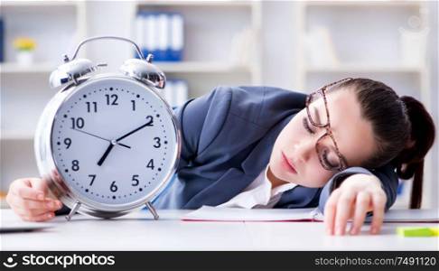 The businesswoman in time management concept sleeping. Businesswoman in time management concept sleeping
