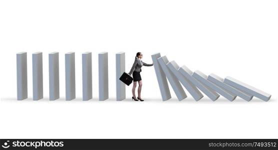 The businesswoman preventing domino effect in business concept. Businesswoman preventing domino effect in business concept