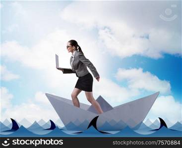 The businesswoman riding paper boat ship in business concept. Businesswoman riding paper boat ship in business concept