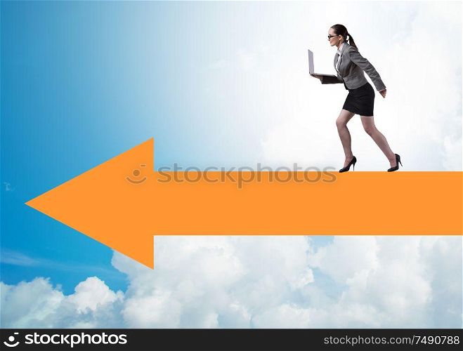 The businesswoman walking on arrow sign. Businesswoman walking on arrow sign