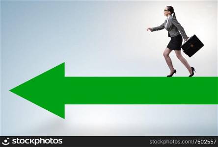The businesswoman walking on arrow sign. Businesswoman walking on arrow sign