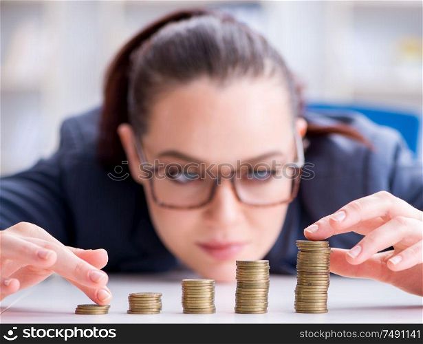 The businesswoman with coins in forex concept. Businesswoman with coins in forex concept