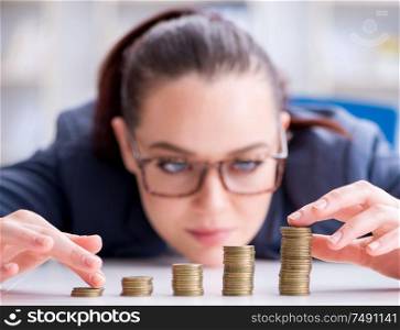 The businesswoman with coins in forex concept. Businesswoman with coins in forex concept