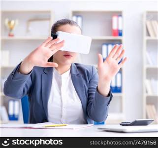 The businesswoman with virtual reality glasses in office. Businesswoman with virtual reality glasses in office