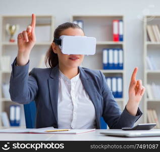 The businesswoman with virtual reality glasses in office. Businesswoman with virtual reality glasses in office