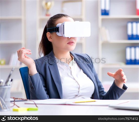 The businesswoman with virtual reality glasses in office. Businesswoman with virtual reality glasses in office