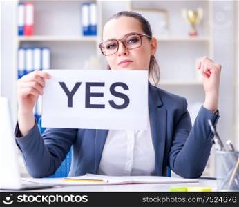 The businesswoman with yes message in office. Businesswoman with yes message in office