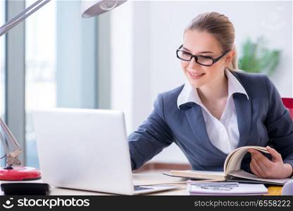 The businesswoman working at her desk in office. Businesswoman working at her desk in office