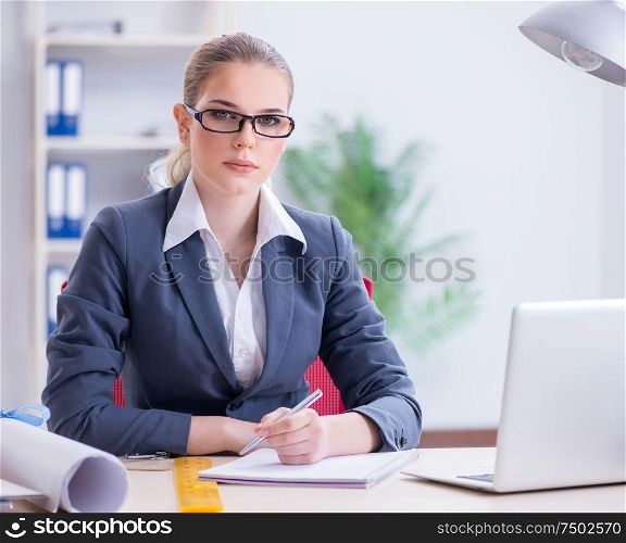 The businesswoman working at her desk in office. Businesswoman working at her desk in office