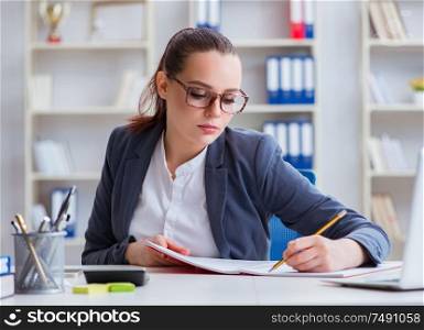 The businesswoman working in the office at desk. Businesswoman working in the office at desk