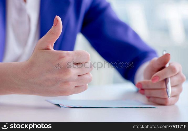 The businesswoman writing notes at desk. Businesswoman writing notes at desk