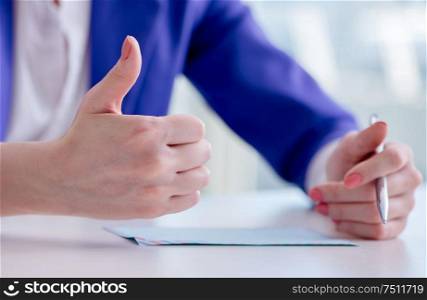 The businesswoman writing notes at desk. Businesswoman writing notes at desk