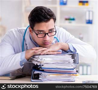 The busy doctor with too much work in hospital. Busy doctor with too much work in hospital