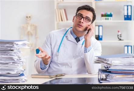 The busy doctor with too much work in hospital. Busy doctor with too much work in hospital