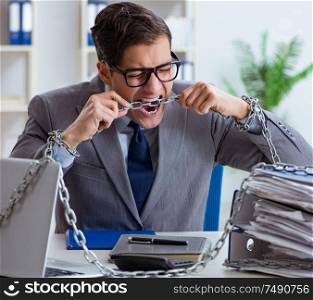 The busy employee chained to his office desk. Busy employee chained to his office desk