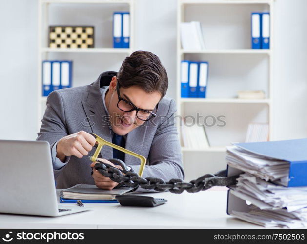 The busy employee chained to his office desk. Busy employee chained to his office desk