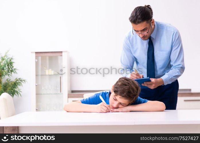 The busy father helping his son to prepare for exam. Busy father helping his son to prepare for exam