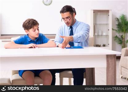 The busy father helping his son to prepare for exam. Busy father helping his son to prepare for exam