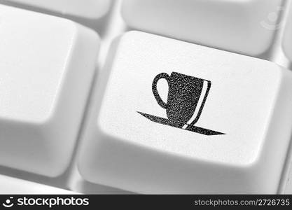 The button with an emblem of a cup of coffee on the keyboard. A working break.