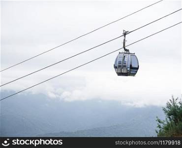 The cable car and grey sky on the background. Bottom view