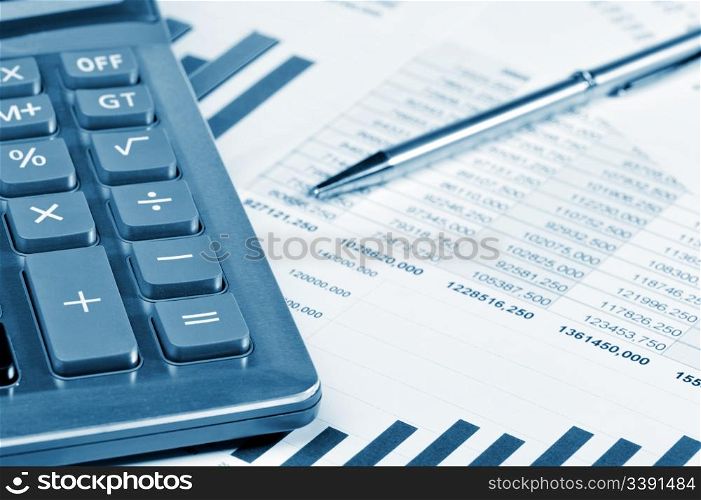 The calculator and the financial report. A workplace of the businessman