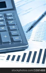 The calculator and the financial report. A workplace of the businessman