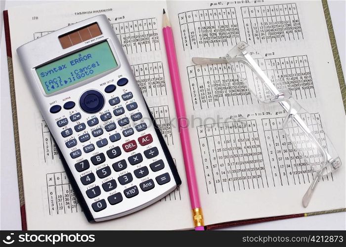 The calculator the pencil and points lie on the table with the data