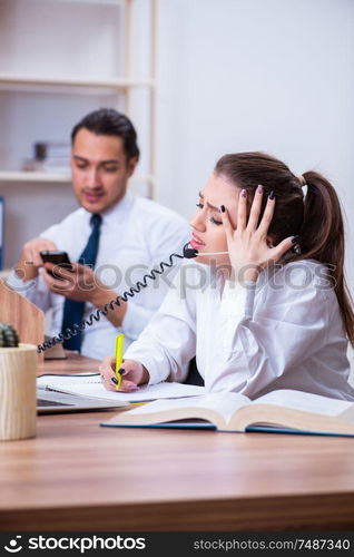 The call center operators working in the office. Call center operators working in the office