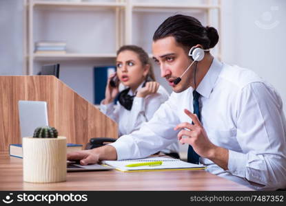 The call center operators working in the office. Call center operators working in the office