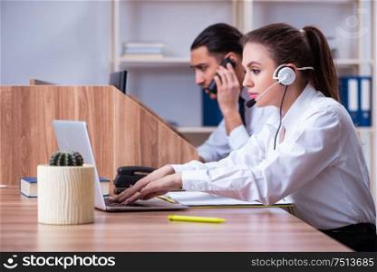 The call center operators working in the office. Call center operators working in the office