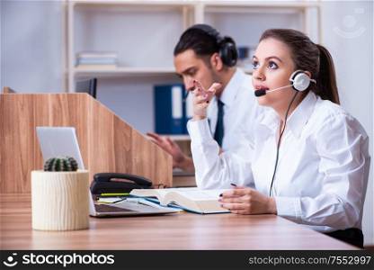 The call center operators working in the office. Call center operators working in the office
