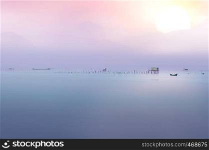 The calm sea reflects the clear sky like a mirror with pastel color. pastel sea background