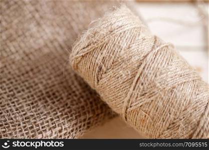 the canvas and the tangle of thread on a wooden background