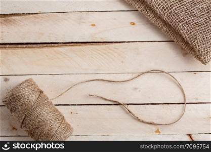 the canvas and the tangle of thread on a wooden background
