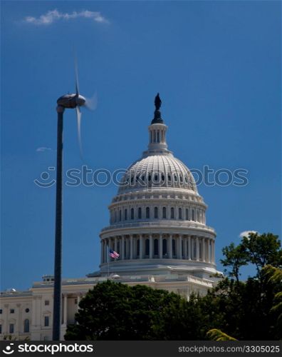 The Capitol building in Washington DC framed wind turbine generating alternative clean power