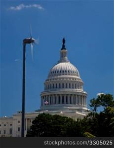 The Capitol building in Washington DC framed wind turbine generating alternative clean power