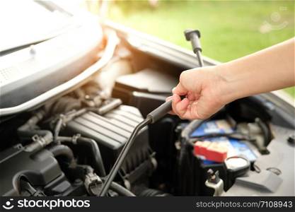 The car is opening the hood to check the engine oil.