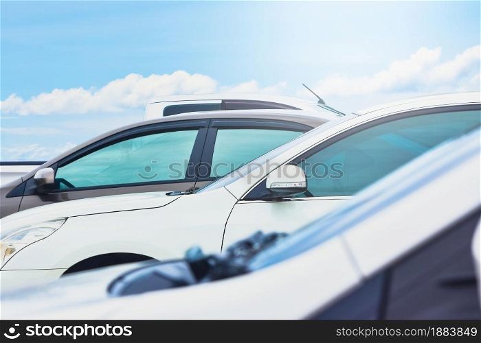 The car is parked in the parking lot with a cloud and blue sky