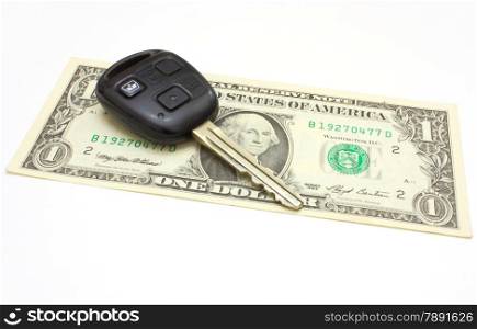 The car key lies on a dollar isolated on white in a background
