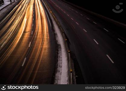 The car light trails on the highway in the night modern city