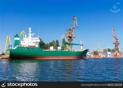 The cargo ship is downloaded near the jetty port.. Gdansk. Sea port.