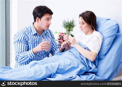 The caring loving husband visiting pregnant wife in hospital. Caring loving husband visiting pregnant wife in hospital