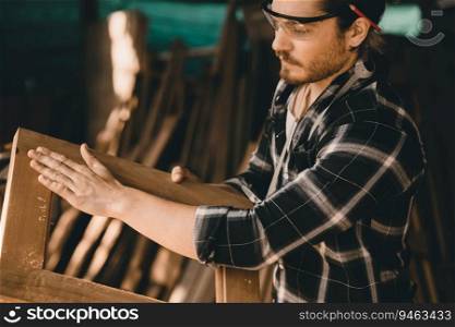 The carpenters man high experienced wood worker making furniture. master of woodcraft male looking at workpiece closeup with fine detail.