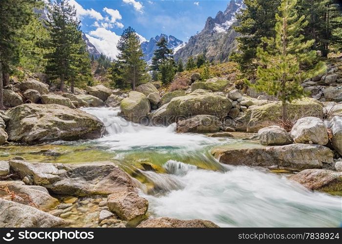 The cascades, waterfalls and snow capped mountains at Restonica valley near Corte in Corsica