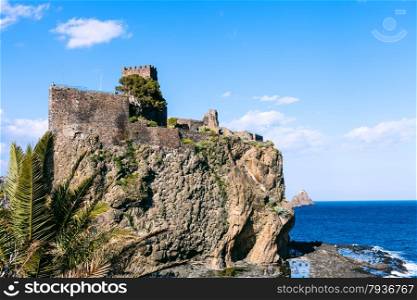 The Castello Normanno in Aci Castello town and Cyclopean Rock (Islands of the Cyclops), Sicily, Italy