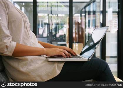 The Casual business woman works online on laptop which hand on keyboard in her house Isolated screen in laptop