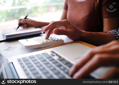 The Casual business woman works online on laptop which hand on keyboard in her house screen in laptop